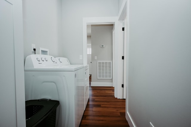 laundry room featuring visible vents, baseboards, washing machine and dryer, laundry area, and dark wood-style floors