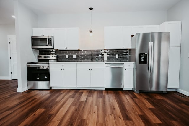 kitchen featuring a sink, stainless steel appliances, decorative backsplash, and white cabinetry