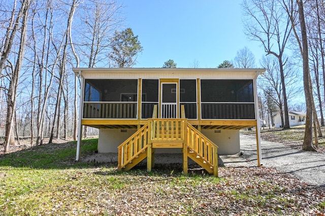 back of house featuring stairs and a sunroom