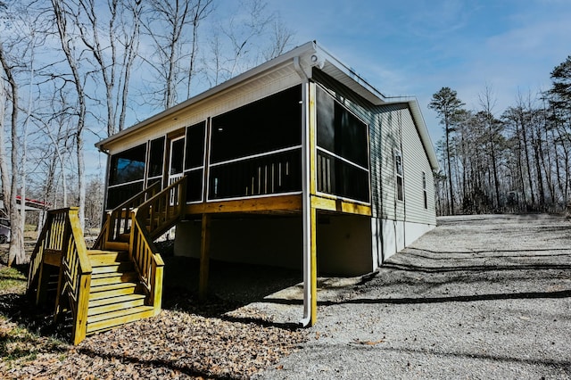 exterior space with stairs and a sunroom