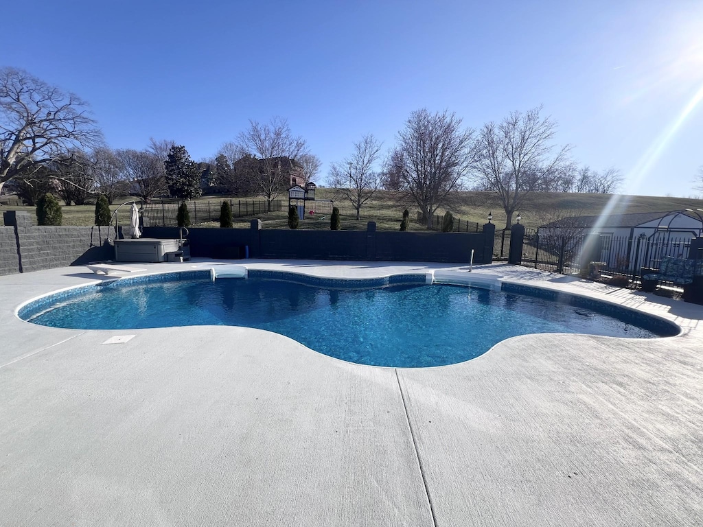 view of swimming pool with a fenced in pool, fence, and a patio area