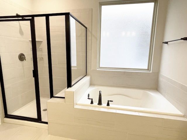 bathroom with a garden tub and a stall shower