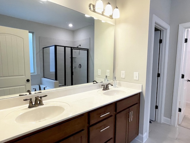 full bathroom with double vanity, a bath, a stall shower, and a sink