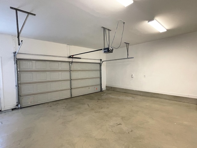 garage with a garage door opener and baseboards