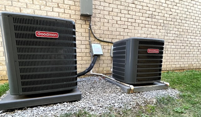 exterior details with brick siding and central AC unit