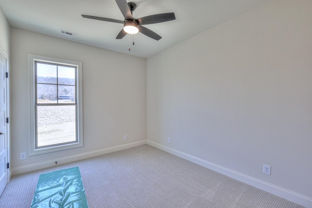 unfurnished room featuring visible vents, light carpet, baseboards, and ceiling fan