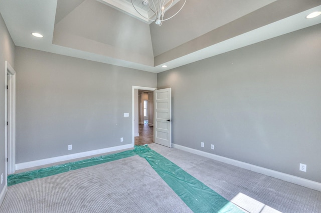 carpeted bedroom with recessed lighting, a high ceiling, and baseboards