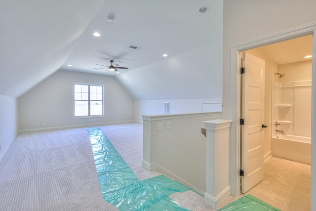 additional living space featuring baseboards, visible vents, lofted ceiling, recessed lighting, and light carpet