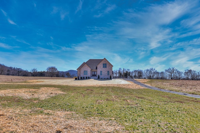 view of front of house with stone siding and a front yard