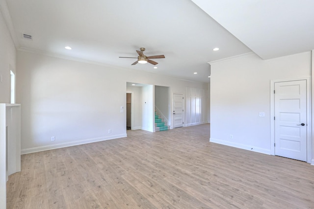 unfurnished room featuring stairway, baseboards, visible vents, crown molding, and light wood-type flooring