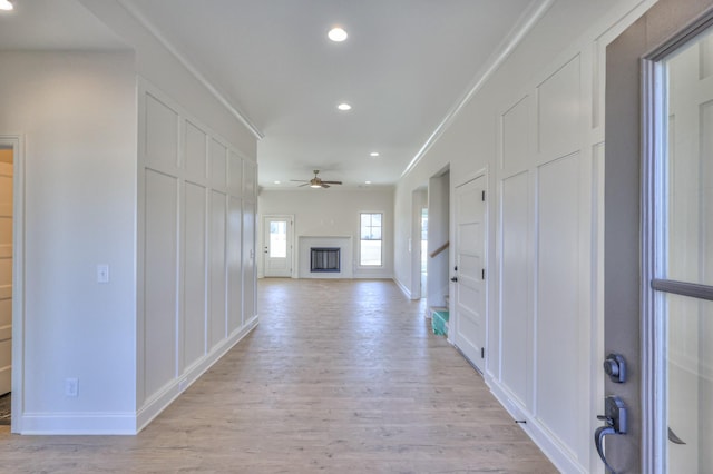 hall with recessed lighting, light wood-type flooring, and baseboards