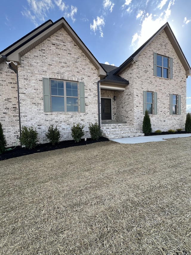 view of front of house featuring brick siding