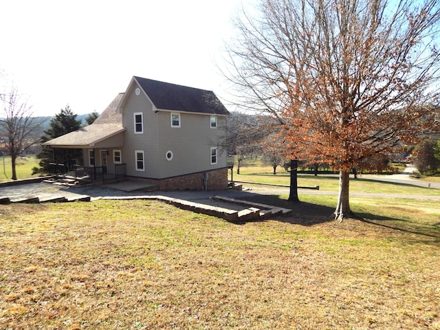 exterior space with a lawn and a patio