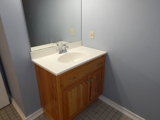 bathroom featuring tile patterned floors, vanity, and baseboards