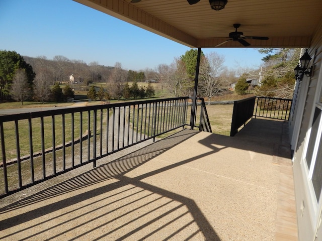 wooden deck with a ceiling fan