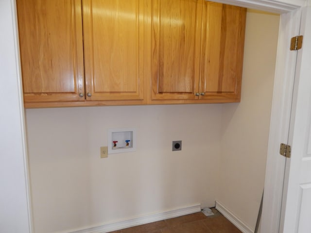 laundry room featuring hookup for a washing machine, cabinet space, baseboards, and hookup for an electric dryer