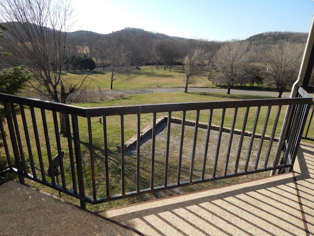 balcony featuring a rural view and a mountain view