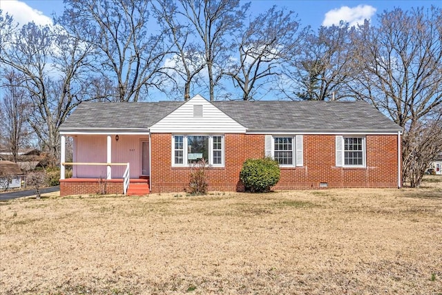 ranch-style house featuring crawl space, brick siding, covered porch, and a front yard