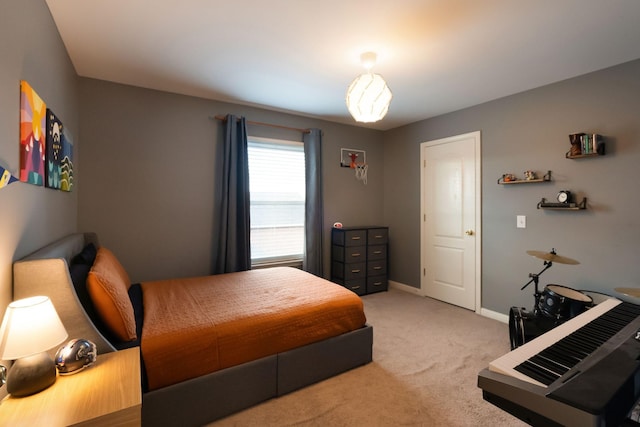 bedroom featuring baseboards and light carpet