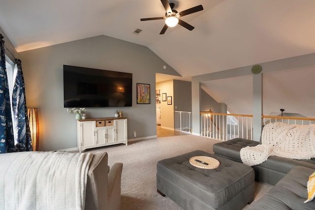 living room with visible vents, baseboards, carpet floors, vaulted ceiling, and a ceiling fan