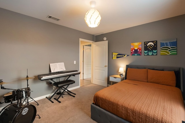 carpeted bedroom with visible vents and baseboards