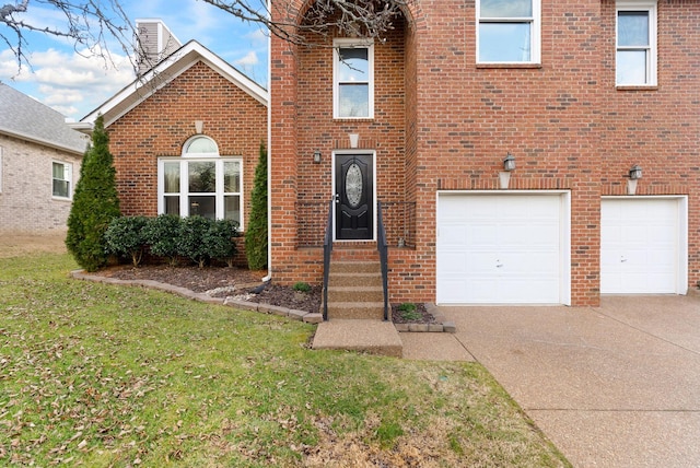 view of front of home with a garage, brick siding, concrete driveway, and a front lawn