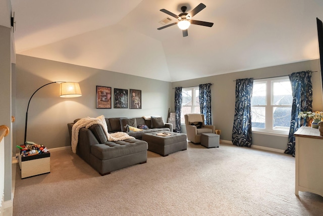 living area with a wealth of natural light, light colored carpet, ceiling fan, and vaulted ceiling