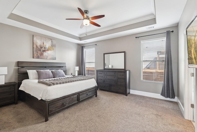 bedroom featuring baseboards, a raised ceiling, light colored carpet, and crown molding