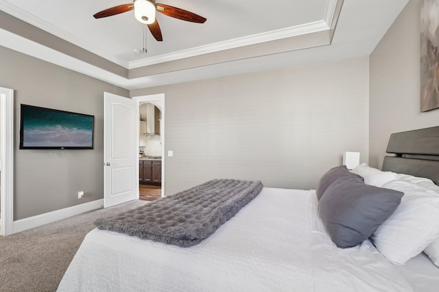 bedroom with arched walkways, crown molding, a tray ceiling, and carpet floors