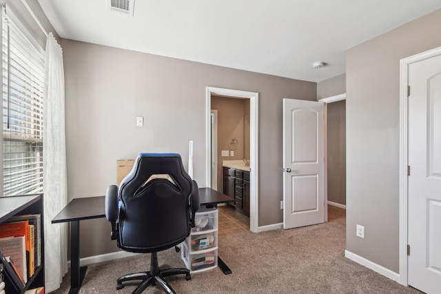 home office with visible vents, light colored carpet, and baseboards