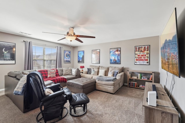 carpeted living area with visible vents, baseboards, and a ceiling fan