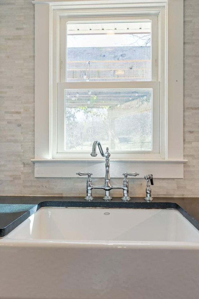 kitchen featuring dark countertops and a sink