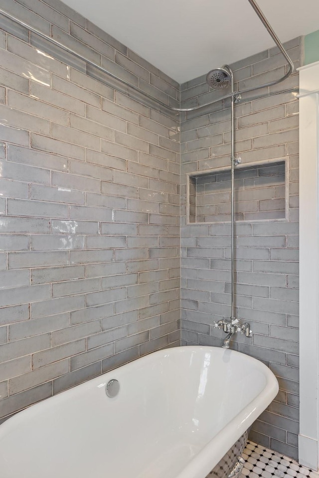 bathroom with a freestanding bath and tile walls