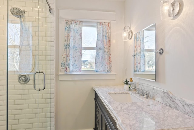 bathroom with vanity and a shower stall