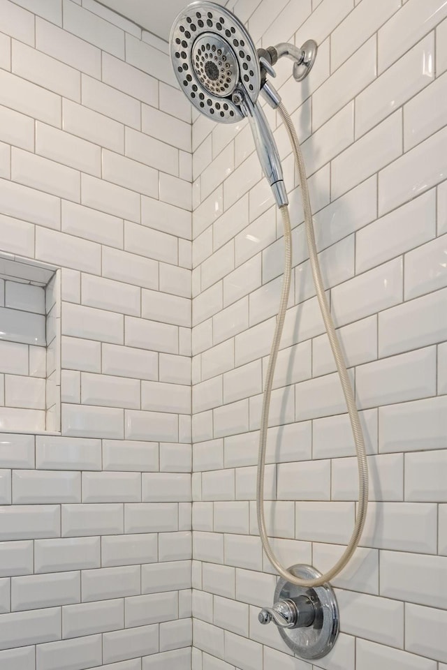 interior details featuring a tile shower