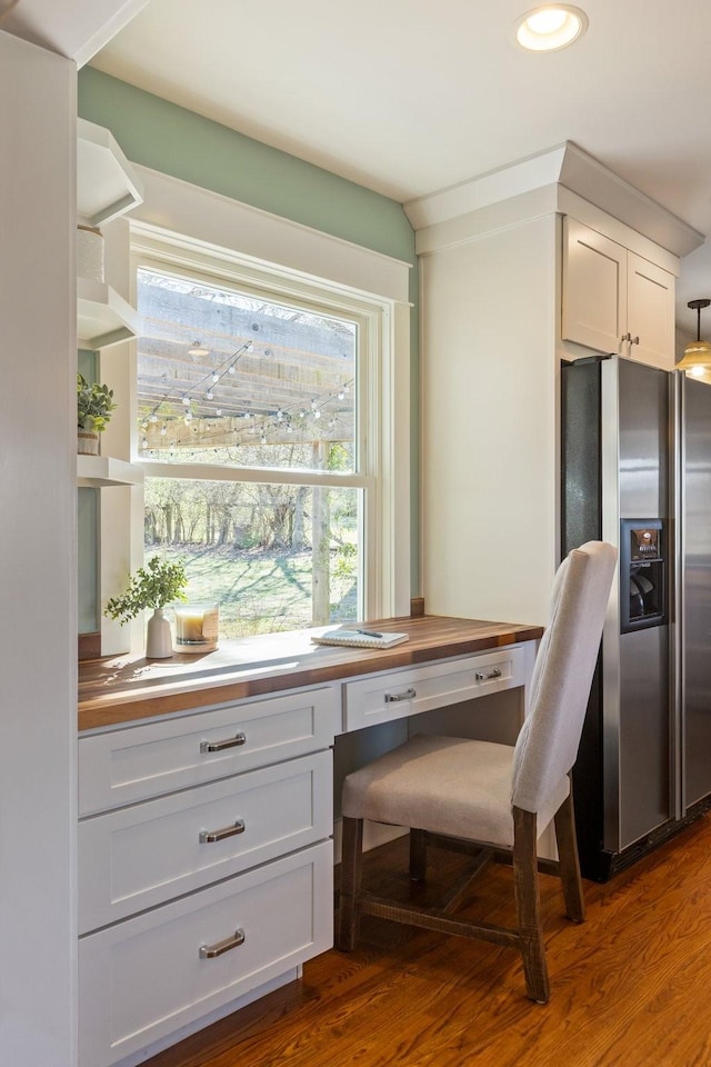 kitchen featuring dark wood finished floors, butcher block countertops, stainless steel fridge, white cabinetry, and open shelves