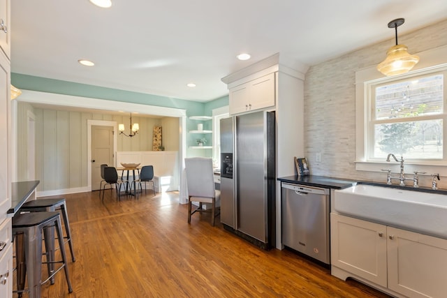 kitchen with a sink, decorative light fixtures, recessed lighting, stainless steel appliances, and dark wood-style flooring