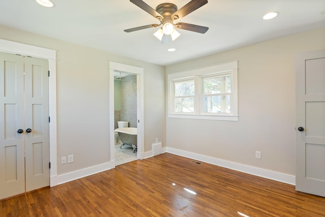 unfurnished bedroom featuring visible vents, recessed lighting, baseboards, and wood finished floors