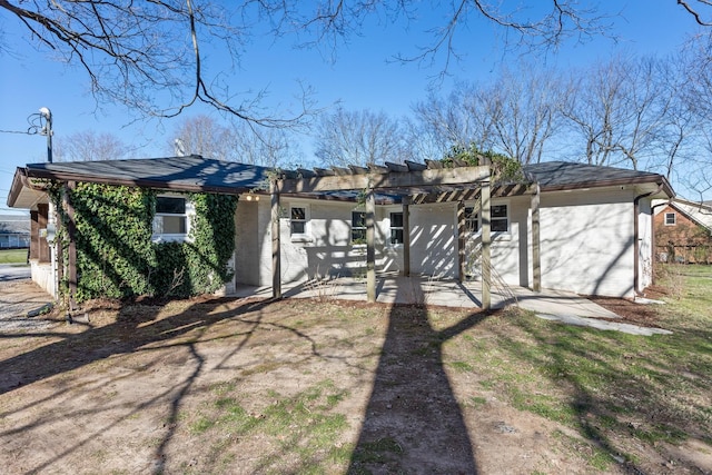 rear view of house with a patio area, brick siding, and a pergola