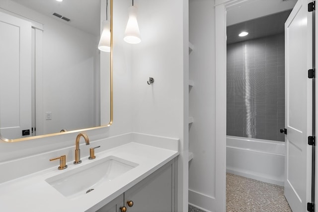 full bath with vanity, visible vents, and shower / washtub combination