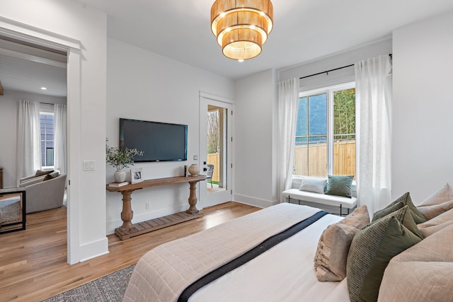 bedroom with recessed lighting, baseboards, and wood finished floors