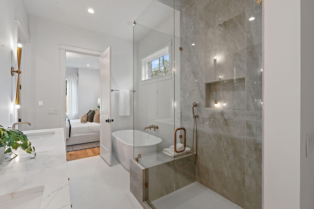 bathroom with a soaking tub, double vanity, a sink, ensuite bathroom, and walk in shower