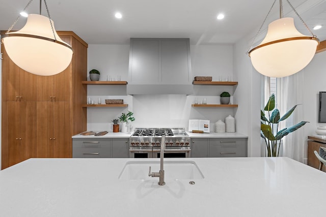 kitchen featuring open shelves, range with two ovens, light countertops, and gray cabinets