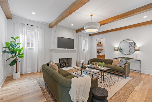 living room with light wood finished floors, a fireplace with flush hearth, recessed lighting, and beam ceiling