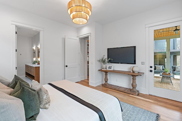 bedroom featuring baseboards and wood finished floors