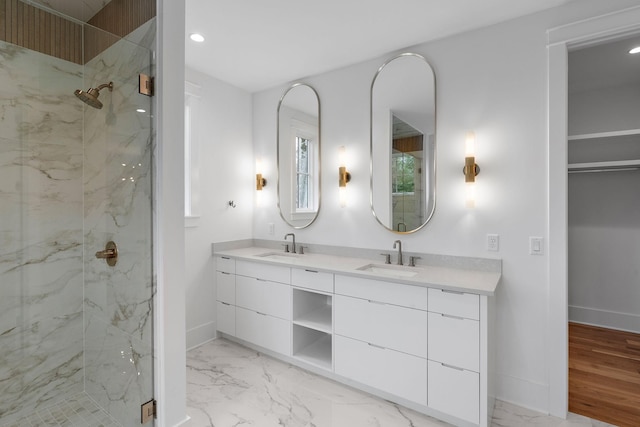 bathroom with a sink, a marble finish shower, and marble finish floor