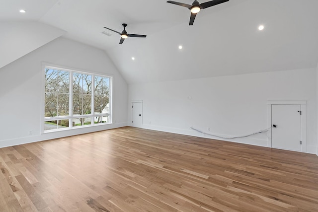 additional living space with baseboards, lofted ceiling, ceiling fan, and light wood finished floors