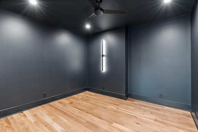 unfurnished room featuring baseboards, wood finished floors, and a ceiling fan