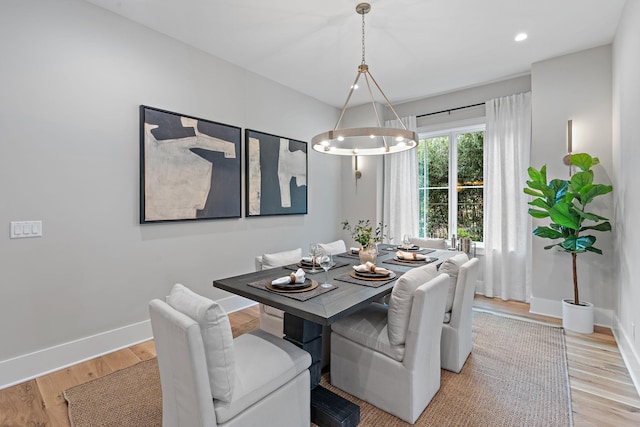 dining room with a chandelier, recessed lighting, light wood-type flooring, and baseboards