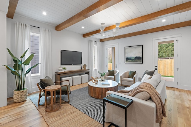 living area featuring beam ceiling, light wood-style flooring, recessed lighting, wood ceiling, and a chandelier